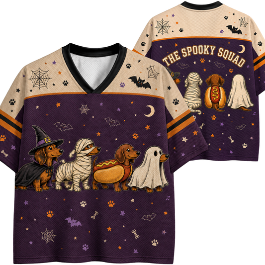 Front and back views of a short-sleeve V-neck t-shirt featuring a Halloween dachshund graphic. The shirt has a beige upper chest and shoulders, a dark purple lower body, and orange stripes on the sleeves.