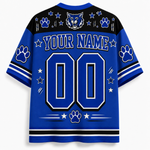Customizable royal blue and black short-sleeve athletic jersey shown from the back, featuring a large 'YOUR NAME' and '00' placeholder design with paw prints, stars, stripes, and a wolf head graphic on the shoulders.