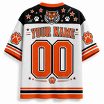 Customizable short-sleeve athletic jersey shown from the back, featuring a white body with orange and black stripes, a black upper yoke, orange paw prints, a tiger head graphic, and large orange '00' with 'YOUR NAME' text.