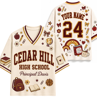 A cream-colored mesh sports jersey shown from both the front and back, featuring 'CEDAR HILL HIGH SCHOOL' and 'Principal Davis' on the front, with customizable 'YOUR NAME' and '24' on the back. The jersey is decorated with school-themed illustrations including a rainbow, backpack, books, and stars in maroon and brown.