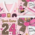 A pink personalized sports jersey mockup collage showing multiple close-up panels of the design: a V-neck collar, decorative lettering, a large glittery number 24 with leopard-print outline, an apple, books, stars, hearts, and a gift box labeled 'Mrs. Emily'.