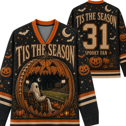A Halloween-themed long-sleeve V-neck sweater shown from both front and back. The dark navy base is decorated with orange and beige graphics, including jack-o'-lanterns, bats, stars, the phrase 'TIS THE SEASON,' a ghost sitting in a stadium, and the number 31 with 'SPOOKY FAN' on the back.