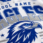 Close-up of a white athletic jersey or sweatshirt fabric with blue and gray varsity-style lettering and a blue eagle head graphic.
