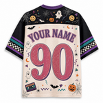 A short-sleeve athletic-style jersey shown from the back, featuring a Halloween theme with 'YOUR NAME' and the number '90' in large pink letters. The shirt has a cream body, black sleeves, purple collar and lettering, and is decorated with spiderwebs, ghosts, pumpkins, bats, and stars.