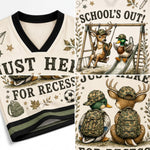 A collage showing a cream mesh V-neck athletic jersey with black trim and a school-themed graphic print. The print includes cartoon deer and ducks wearing camouflage backpacks and hats, with text such as 'SCHOOL'S OUT!' and 'JUST HERE FOR RECESS,' plus small decorative icons like stars, leaves, a soccer ball, and a backpack.
