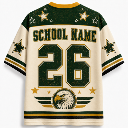 Customizable school jersey shirt shown from the back, featuring 'SCHOOL NAME' and the number '26' in dark green with gold outlines on an off-white background. The shoulders and sleeves have dark green panels with gold stars, and the lower back features an eagle graphic.