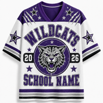 A white and purple short-sleeve V-neck jersey-style shirt with 'WILDCATS' across the chest, a wildcat head logo, numbers 20 and 26, and 'SCHOOL NAME' at the bottom, shown on a light gray background.