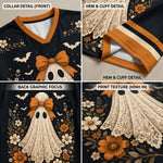 Four-panel product detail collage showing a black V-neck top with an orange collar, cream lace-like ghost graphic, floral print, bats, and a large orange bow. Text labels highlight collar detail, hem and cuff detail, back graphic focus, and print texture.