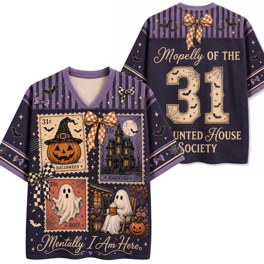A Halloween-themed short-sleeve V-neck t-shirt shown from both front and back. The shirt features a dark purple base with a collage of vintage postage stamps depicting a haunted house, a jack-o'-lantern, a ghost, and a witch hat, accented with orange-and-white checkered bows, black bats, and gold text reading 'Mopelly of the 31 United House Society' and 'Mentally I Am Here.