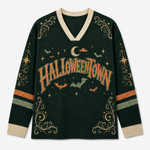 A dark forest green long-sleeve V-neck sweater with a distressed orange 'HALLOWEENTOWN' graphic across the chest, decorated with bats, stars, moons, and gold swirl patterns on the sleeves and hem.