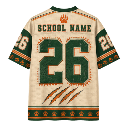 Customizable short-sleeve athletic jersey shown from the back, featuring a cream mesh body with green and orange accents, large number 26, placeholder 'SCHOOL NAME' text, paw print details, and claw graphics.