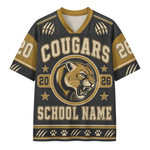 A custom short-sleeve V-neck jersey with a dark charcoal gray body and gold accents, featuring a cougar mascot logo, 'COUGARS' text, and placeholder text 'SCHOOL NAME'.