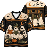 A Halloween-themed short-sleeve V-neck t-shirt shown from both front and back. The design features three cute ghosts reading books, a witch with a hat, a black cat, pumpkins, candles, bats, and a bookshelf on a black background with orange and beige accents.