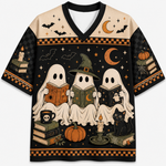 A short-sleeve V-neck t-shirt featuring a detailed Halloween graphic print. The design shows three ghosts reading books, a witch hat, a black cat, pumpkins, candles, and bats against a black and beige background with orange accents.