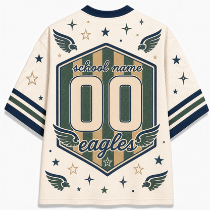 A cream-colored mesh athletic jersey shown from the back, featuring a large central shield graphic with the text 'school name', '00', and 'eagles' in navy and tan. The jersey has navy and tan striped sleeves with matching navy and tan stars and eagle wing motifs.