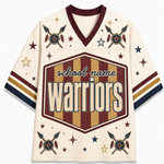 A cream-colored retro hockey-style jersey with a V-neck, featuring a large central shield graphic that reads 'school name warriors' in distressed maroon and gold stripes. The jersey is decorated with crossed arrows, stars, and feathers in maroon, navy, and gold on the sleeves and shoulders.