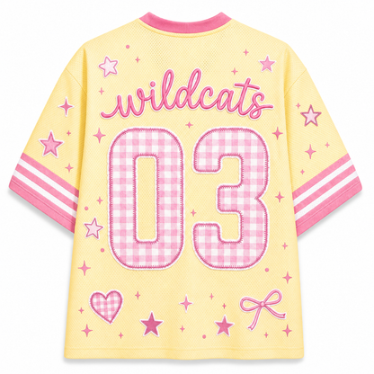 Back view of the Chaotic Club jersey showcasing 'wildcats' cursive text above a large pink gingham patterned number 03 with pink star doodles.