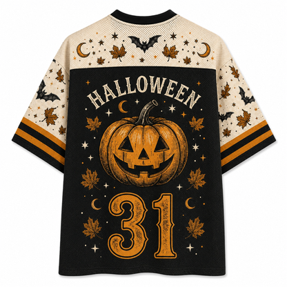 A short-sleeve athletic-style shirt shown from the back, featuring a black center panel with a large carved pumpkin, the word HALLOWEEN, and the number 31 in orange, surrounded by stars, moons, leaves, and bats. The sleeves and upper back are cream with matching Halloween motifs and orange stripe accents.