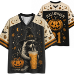 A Halloween-themed V-neck t-shirt shown from both front and back. The shirt features a black body with cream-colored sleeves and collar trim, decorated with spooky graphics including a raccoon in a witch hat holding an iced drink, a jack-o'-lantern bucket, bats, crescent moons, stars, and the word 'HALLOWEEN' on the back.
