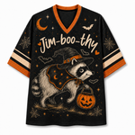 A black V-neck athletic-style T-shirt with orange trim and striped sleeves, featuring a large Halloween graphic of a raccoon in a witch hat holding a jack-o'-lantern, with stars, bats, spiderwebs, and the text 'Jim-boo-thy' across the front.