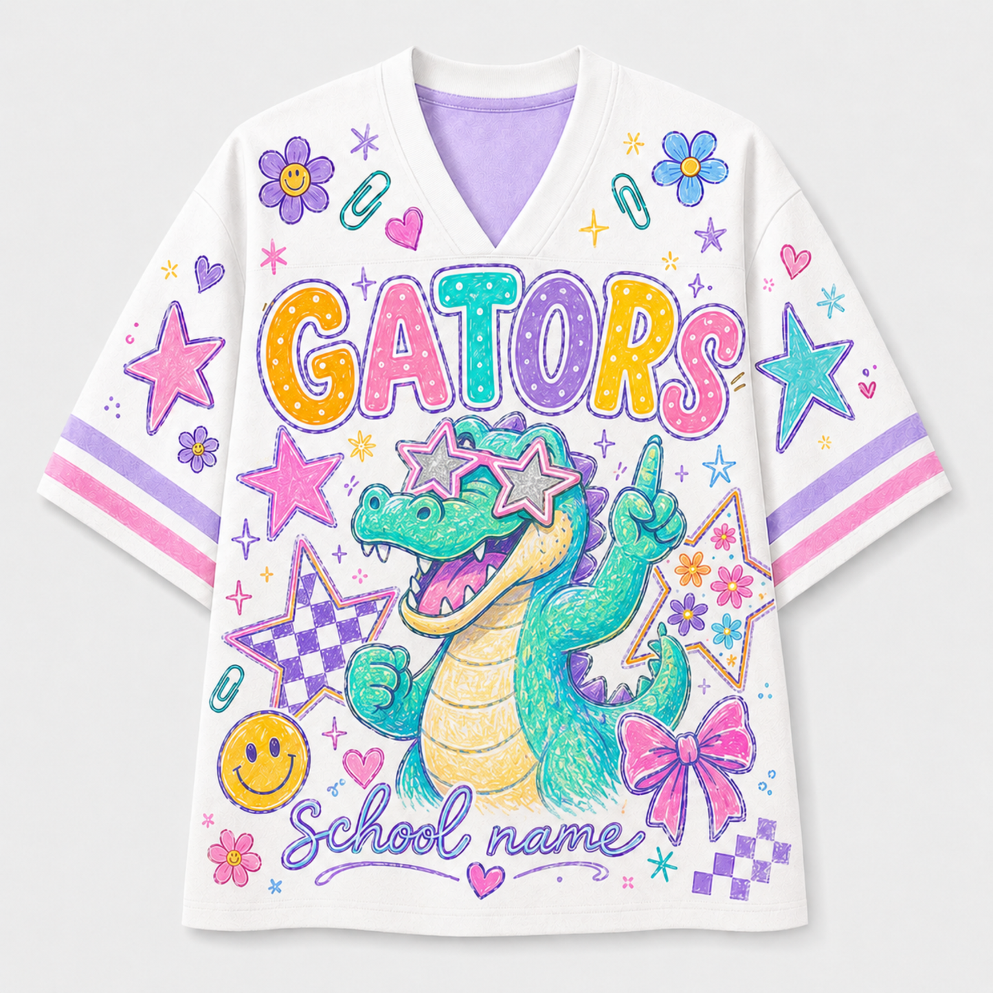 A white short-sleeve V-neck jersey-style shirt with colorful school-themed graphics, including the word "GATORS" in large multicolor letters, a green alligator wearing star-shaped sunglasses, pink bows, stars, flowers, and the text "School name" on a light gray background.