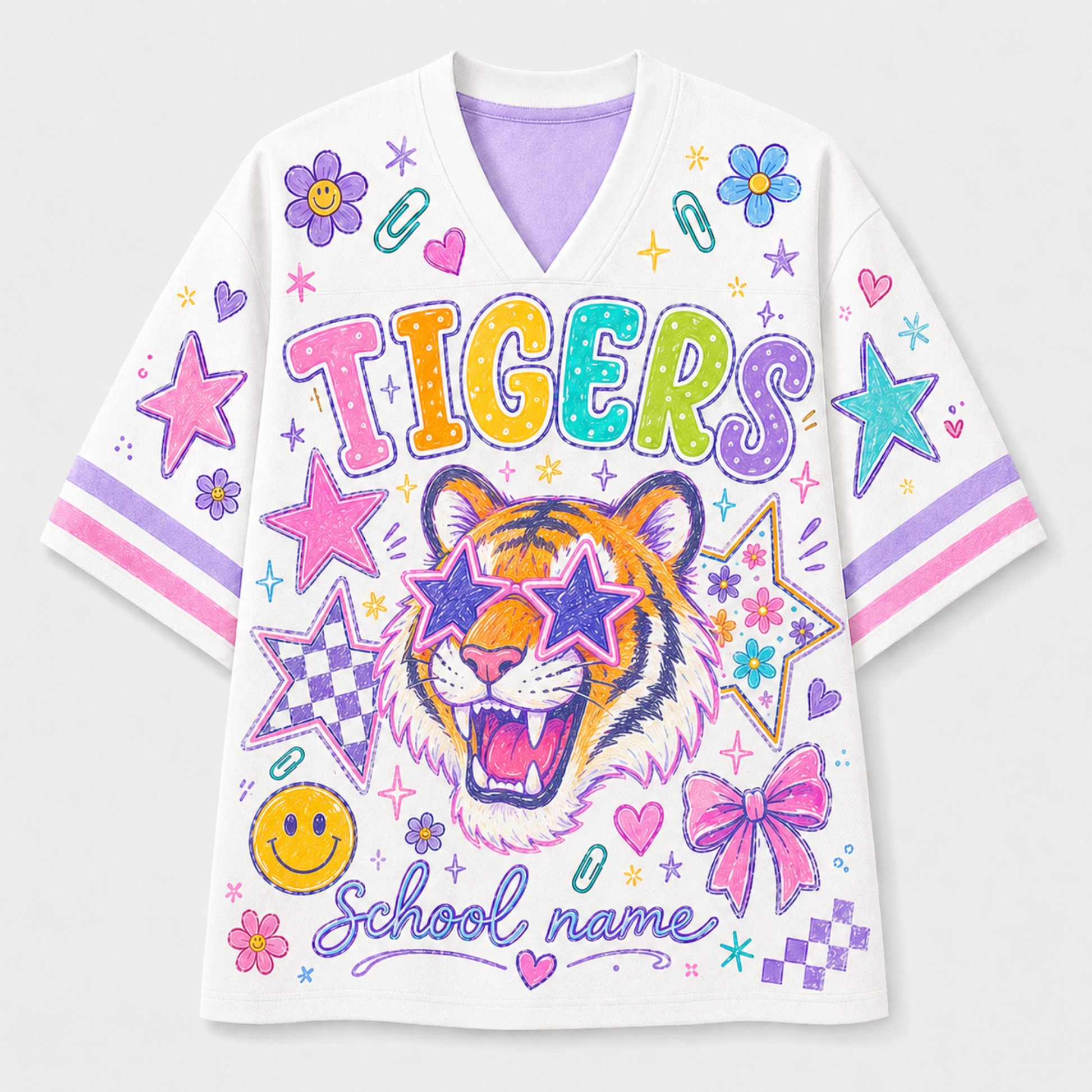 A white short-sleeve V-neck t-shirt featuring a colorful graphic design with a tiger wearing star-shaped sunglasses, the word 'TIGERS' in rainbow letters, and 'School name' script. The shirt is decorated with stars, bows, smiley faces, and pink and purple stripes on the sleeves.