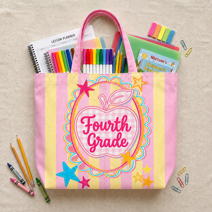 Pink tote bag with 'Fourth Grade' design, surrounded by school supplies on a beige background