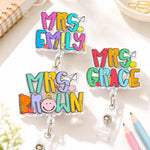 ChaoticClub Custom Name Teacher Badge Reel group view featuring personalized colorful acrylic nameplates for Mrs. Emily, Mrs. Brown, and Mrs. Grace.
