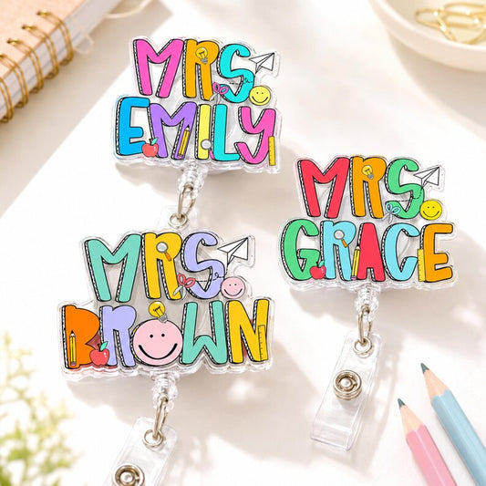 ChaoticClub Custom Name Teacher Badge Reel group view featuring personalized colorful acrylic nameplates for Mrs. Emily, Mrs. Brown, and Mrs. Grace.