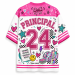 A white and pink short-sleeve graphic t-shirt with 'PRINCIPAL 24' printed on the back, decorated with school-themed doodles like stars, hearts, a smiley face, and a disco ball.