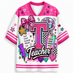 A white and pink V-neck graphic t-shirt featuring a large glittery pink letter 'T' and the word 'Teacher' in script, decorated with stars, hearts, a disco ball, a lightning bolt, and a pink glitter bow on the chest.