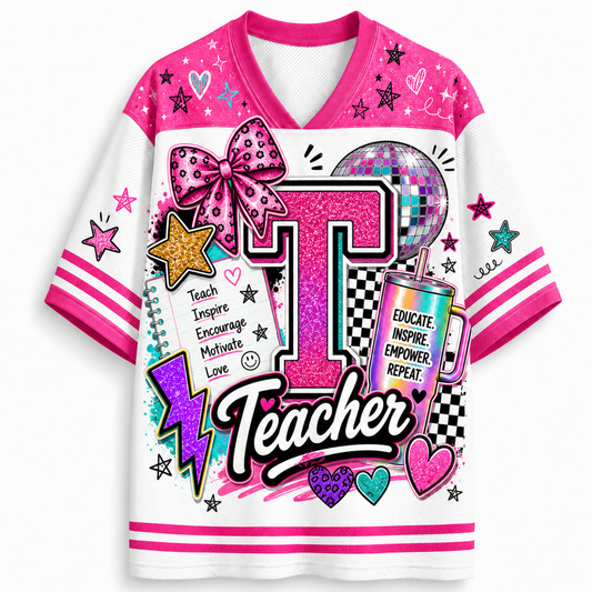 A white and pink V-neck graphic t-shirt featuring a large glittery pink letter 'T' and the word 'Teacher' in script, decorated with stars, hearts, a disco ball, a lightning bolt, and a pink glitter bow on the chest.