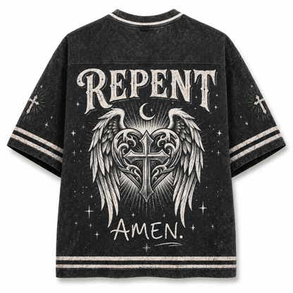 A black acid-wash t-shirt with a distressed gothic graphic on the back featuring the word 'REPENT' in a distressed white font, an angel wing and cross design, a crescent moon, and 'AMEN.' written below.