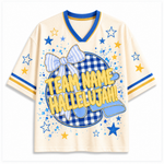 A cream-colored short-sleeve V-neck jersey-style shirt with blue and yellow trim, featuring a large front graphic with a blue-and-white gingham circle, a striped bow, blue stars, and yellow text reading 'TEAM NAME HALLELUJAH!'.