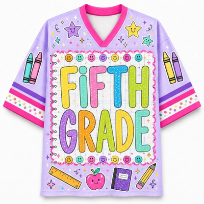 A light purple short-sleeve V-neck jersey-style shirt with a colorful 'FIFTH GRADE' graphic on the front, decorated with crayons, smiley faces, stars, a ruler, an apple, and a notebook.