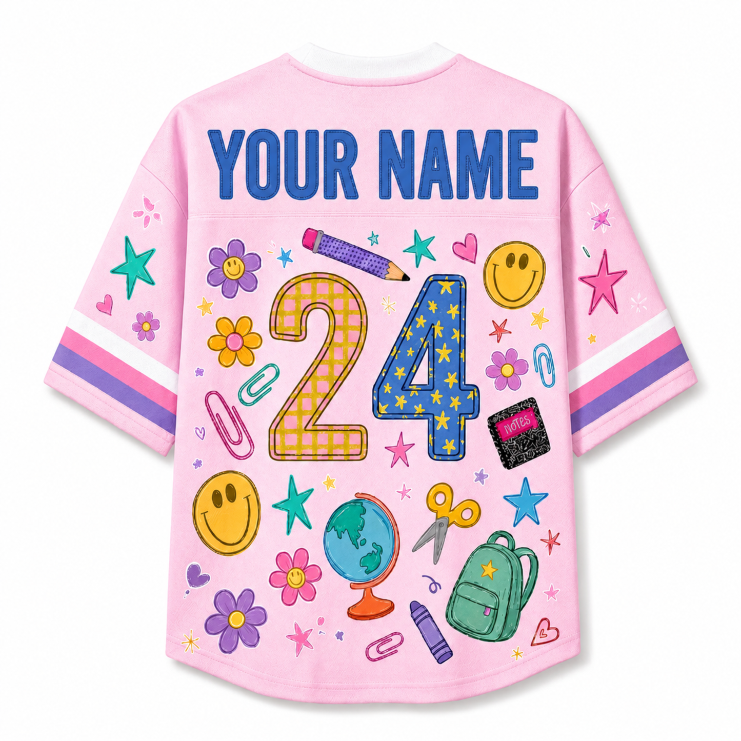 A pink short-sleeve t-shirt shown from the back, featuring a customizable 'YOUR NAME' text at the top and a colorful graphic of the number '24' surrounded by school-themed doodles like stars, flowers, a globe, and stationery.