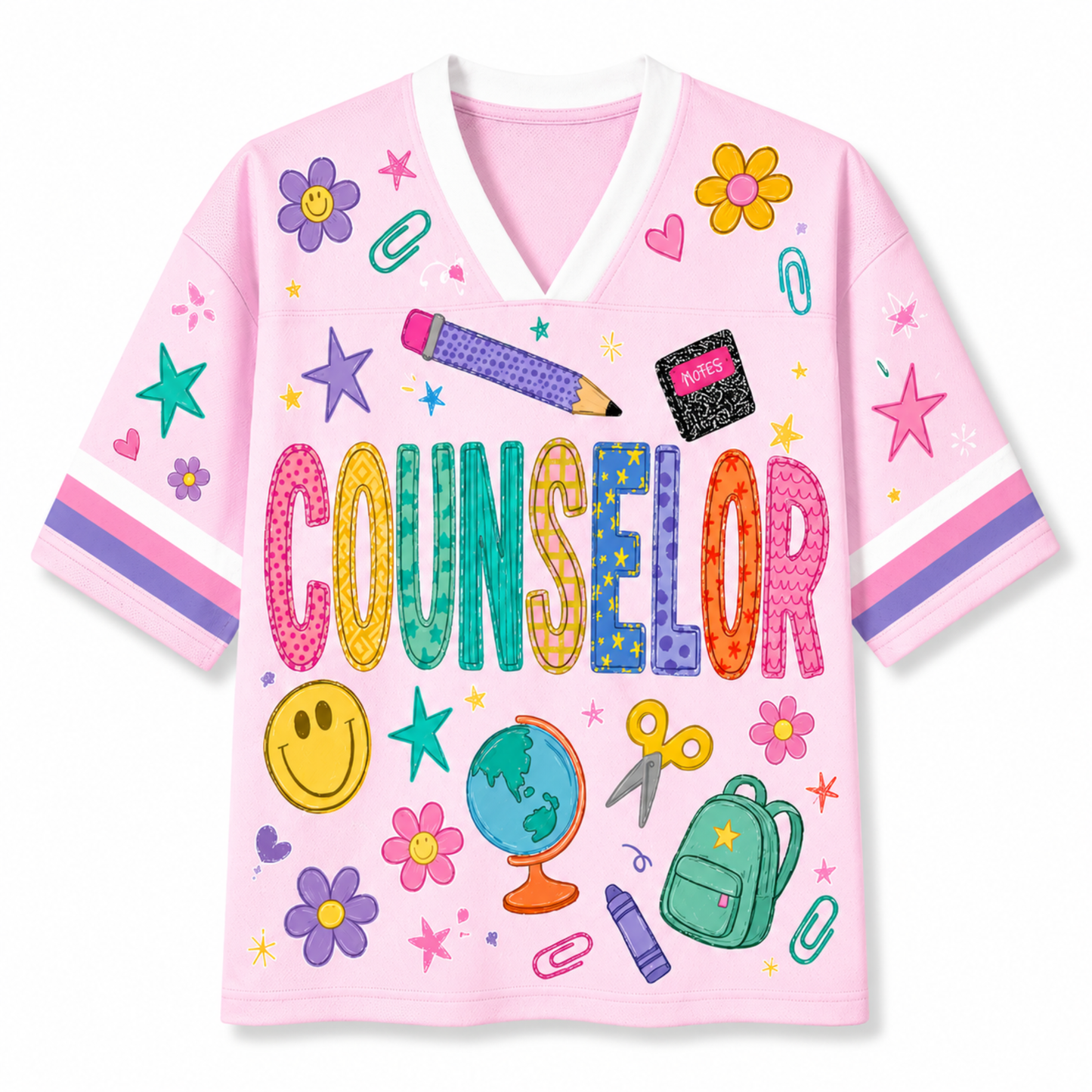 A pink short-sleeve V-neck t-shirt with a colorful school-themed graphic print featuring the word 'COUNSELOR' and illustrations of flowers, smiley faces, a globe, a backpack, and stationery on a white background.