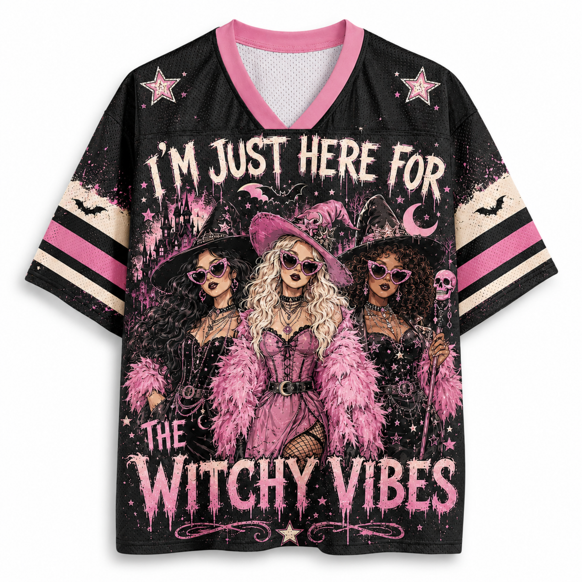 A women's short-sleeve V-neck jersey-style top with a black base and a large witch-themed graphic print. The design features three illustrated witches in pink and black attire, stars, bats, a crescent moon, and the text 'I'M JUST HERE FOR THE WITCHY VIBES.
