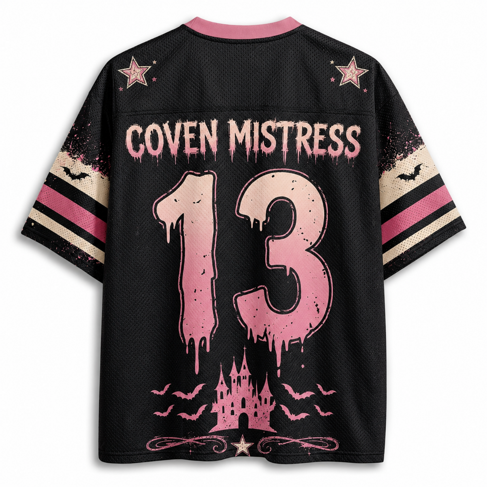 A black short-sleeve jersey-style shirt shown from the back, featuring pink and beige graphic details. The back has a pink collar, pink stars, the text 'COVEN MISTRESS' across the upper back, a large distressed pink number '13' in the center, and a pink castle with bats near the hem.