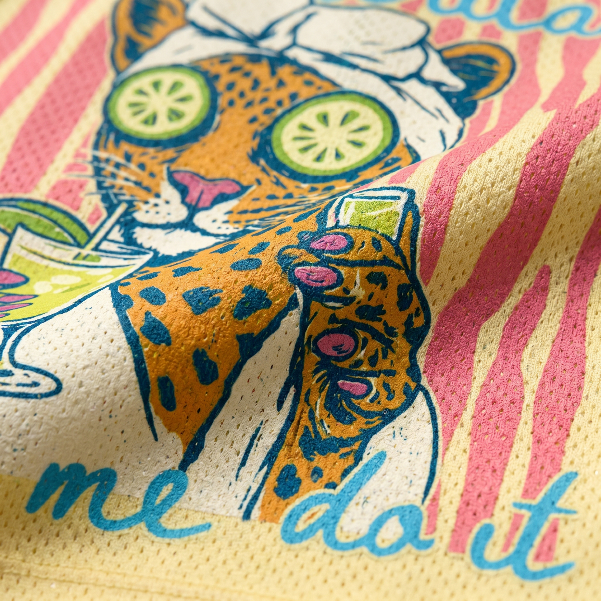 Close-up of the leopard spa graphic on the yellow mesh fabric, showing the fine print details of the cucumber slices and the drink held by the leopard.