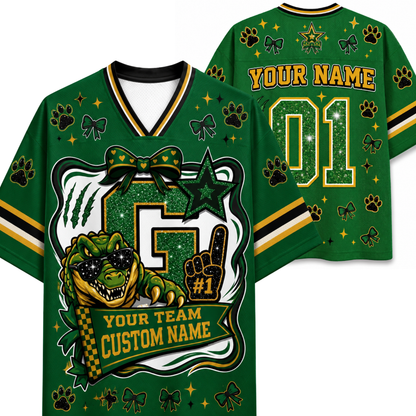 A green custom football jersey shown from the front and back, featuring a large glittery number 5, a green alligator mascot wearing sunglasses, paw prints, bows, stars, and customizable text reading 'YOUR NAME' and 'YOUR TEAM CUSTOM NAME'.