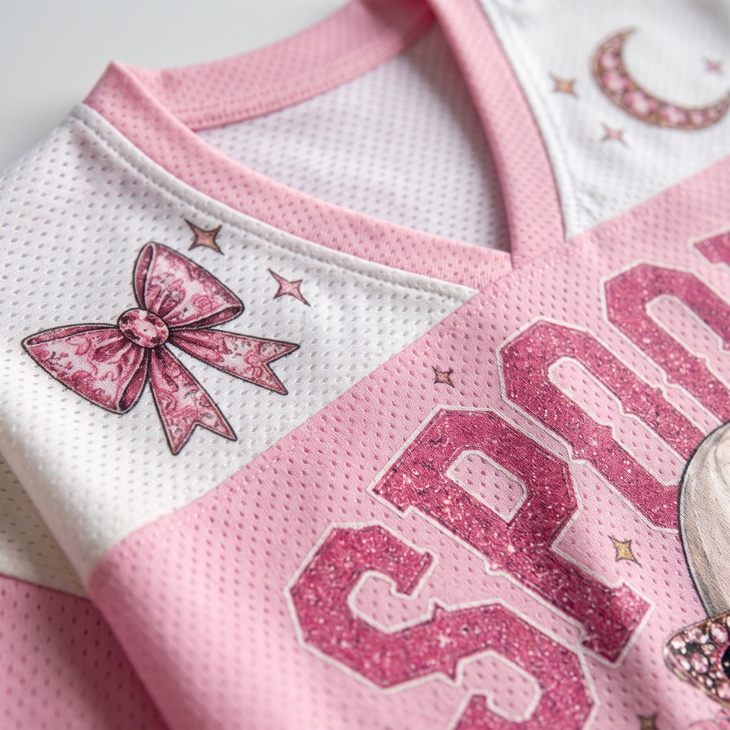 Close up view of the pink V-neck collar on ChaoticClub glam ghost jersey showcasing the white mesh paneling and a cute pink leopard bow design.