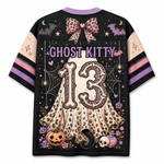A black short-sleeve t-shirt with a detailed Halloween graphic on the back. The design features a large beige ghost with a leopard print, the number '13' in a spooky font, 'GHOST KITTY' text, pumpkins, a skull, bats, and purple accents.