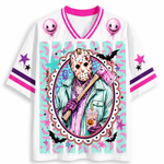 A white short-sleeve athletic-style jersey shirt with bright pink and purple trim, featuring a large colorful Halloween-themed graphic on the front. The design includes a masked figure holding an axe inside an oval frame, pink balloons, stars, bats, and a dripping paint effect on a white background.