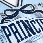Close-up of a decorative item with 'PRINCESS' text on a blue background