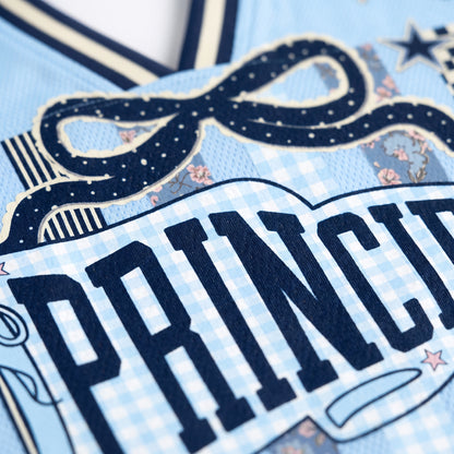 Close-up of a decorative item with 'PRINCESS' text on a blue background