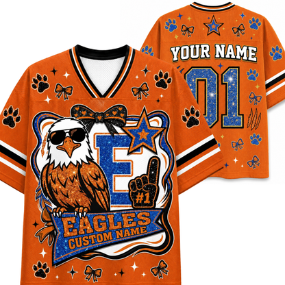 Custom orange Eagles-themed sports jersey shown from both front and back. Features a large eagle graphic with sunglasses and a #1 foam finger, customizable name and number text, paw prints, bows, stars, and striped sleeve accents.