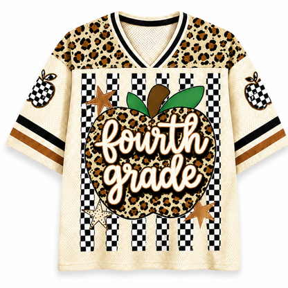 A short-sleeve V-neck jersey-style shirt with a cream mesh base, leopard-print shoulder panels, black-and-white checkered sleeve and front panel details, and a large central apple graphic reading 'fourth grade' in script over a leopard print background.