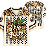 A custom first-grade themed athletic jersey shown from both front and back. The design features a leopard print apple graphic with the text 'first grade' on the front, checkered stripes, and a leopard print number 24 on the back with the placeholder 'Your Name'.