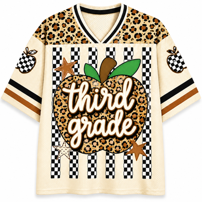 A short-sleeve V-neck jersey-style shirt with a cream mesh base and a bold autumn-themed graphic. The shoulders and upper chest feature a leopard-print pattern, while the lower body has black-and-white checkered stripes.